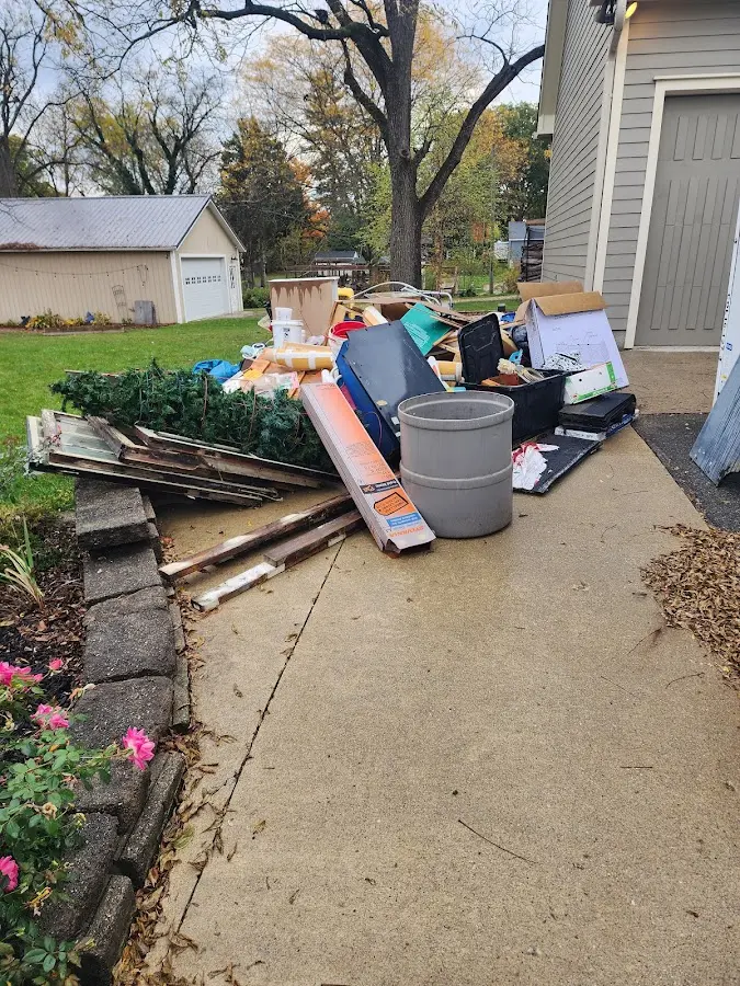 Dumpster being loaded with debris for 12 Yard Dumpster Rental in Danby